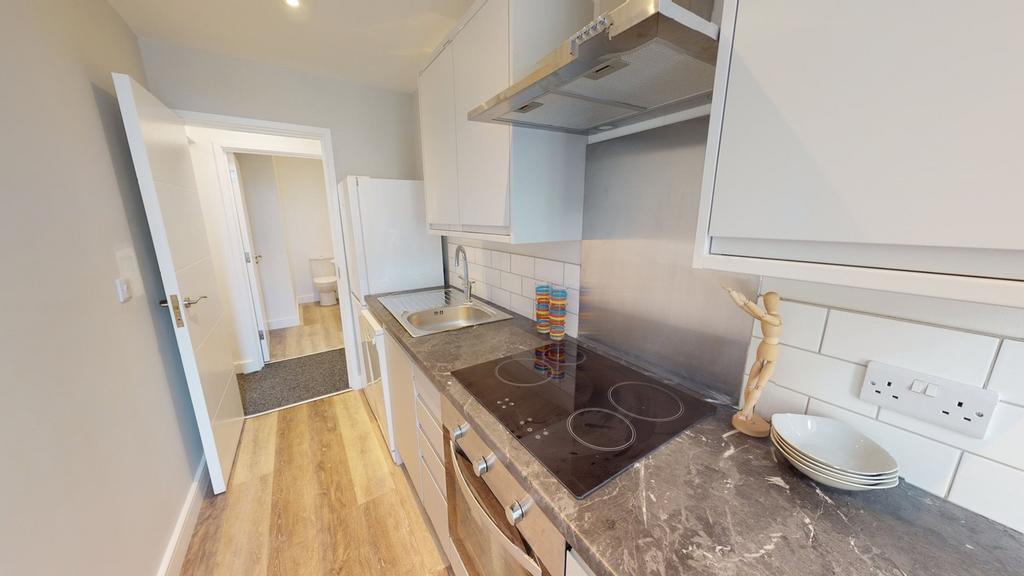 A modern and tidy kitchenette with ample counte...