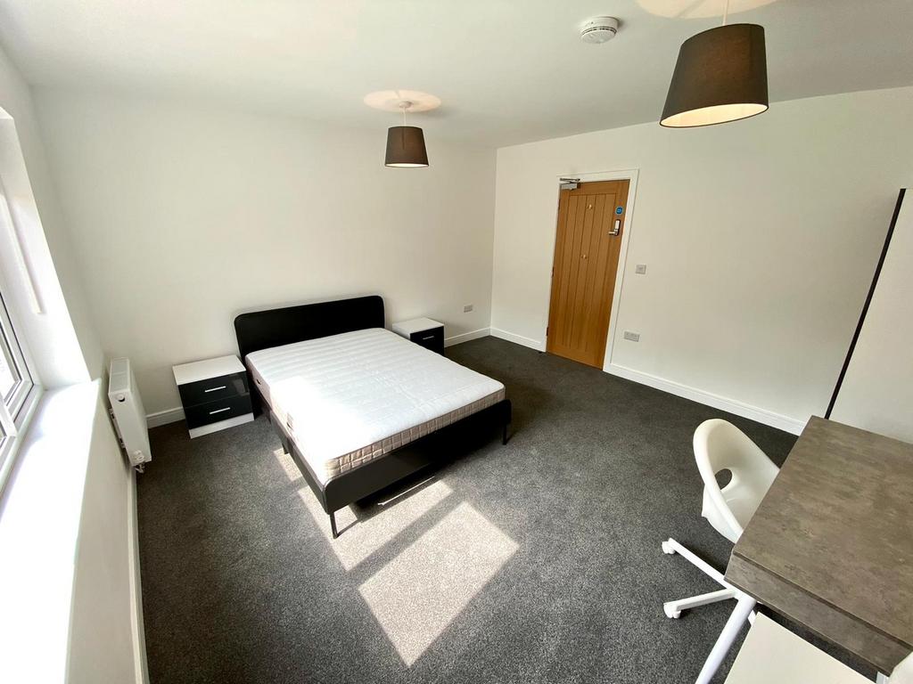 A spacious and bright double bedroom, perfect f...