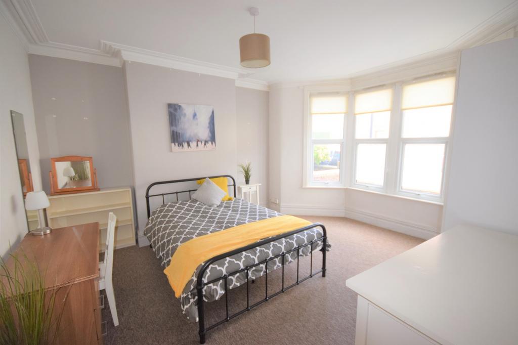 A spacious and bright double bedroom featuring ...