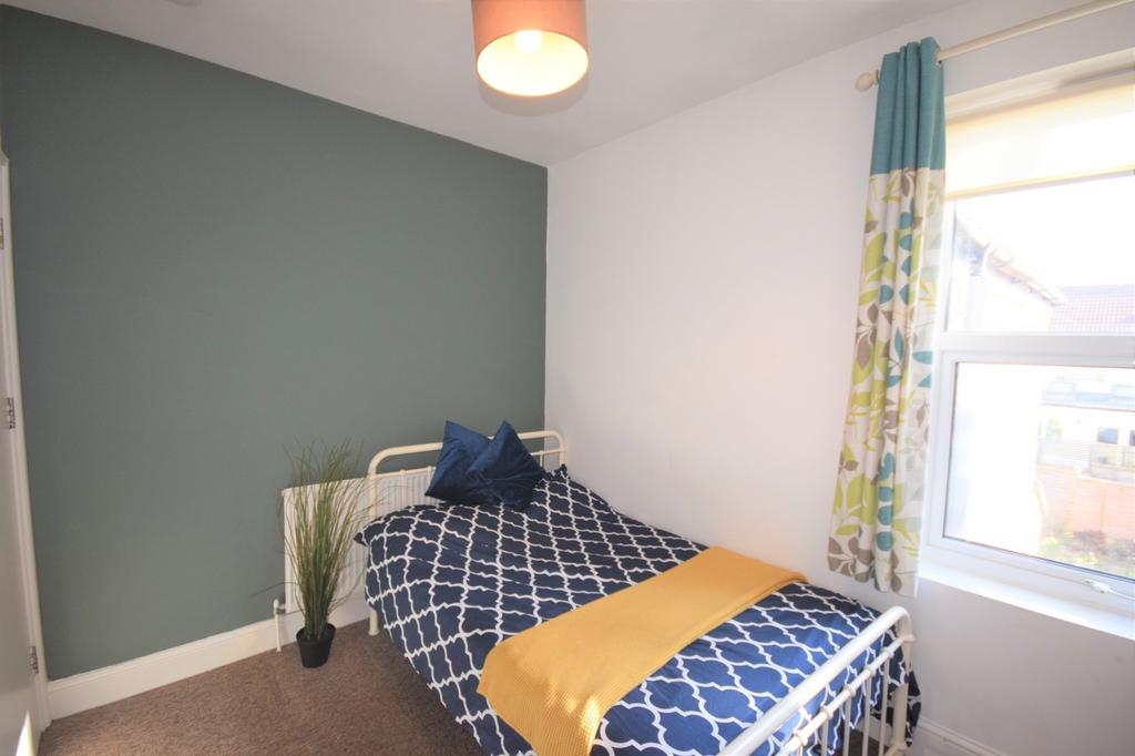 A bright and inviting double bedroom with styli...