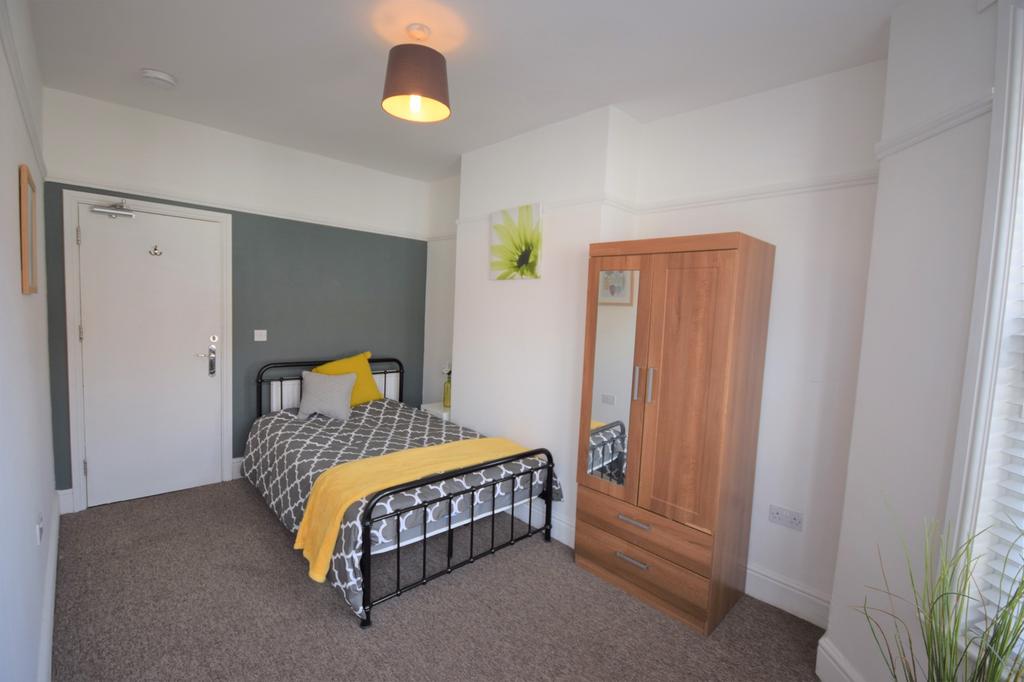 A bright and inviting double bedroom featuring ...