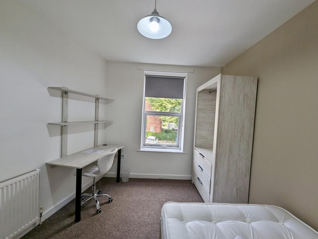 A bright and spacious double bedroom featuring ...