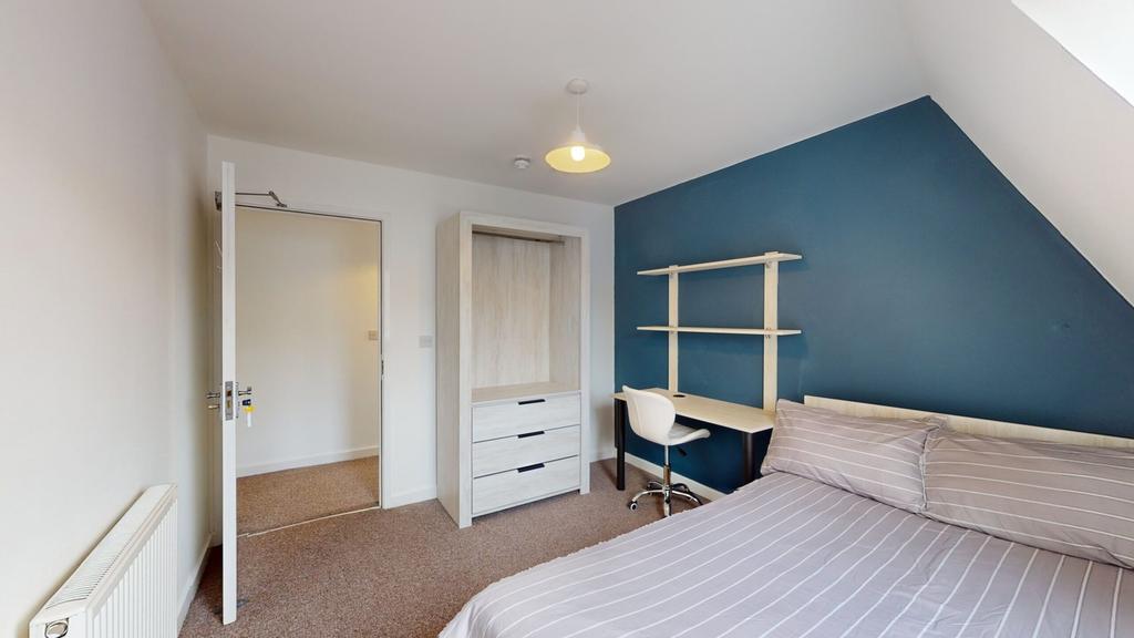 A bright and spacious double bedroom featuring ...