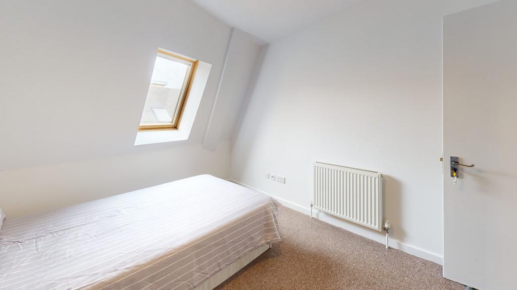 A bright and tidy double bedroom featuring a co...