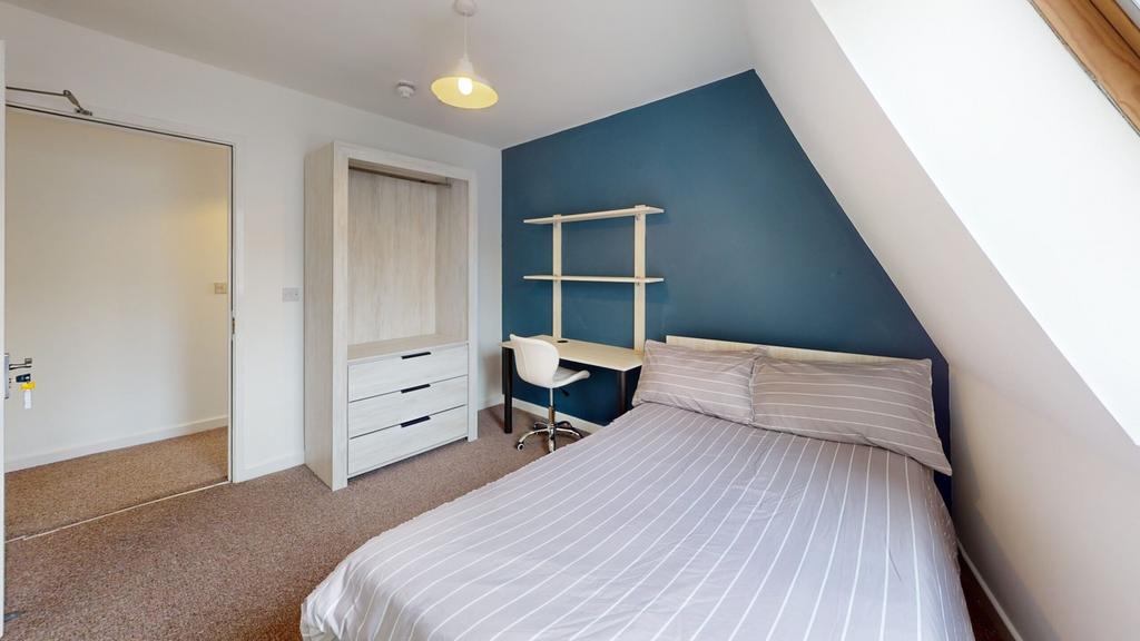 A bright and inviting double bedroom with a mod...