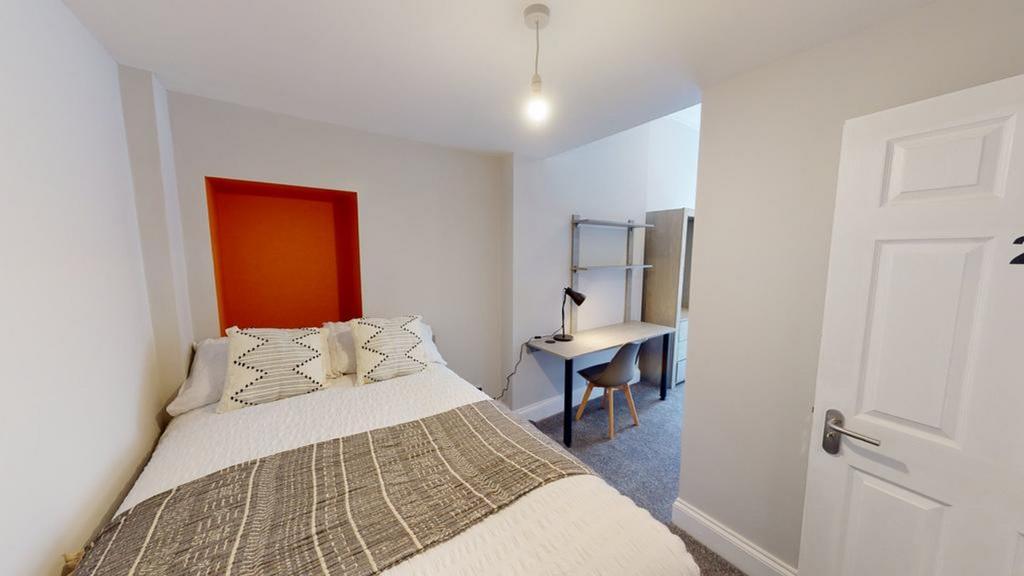 A bright and inviting double bedroom featuring ...