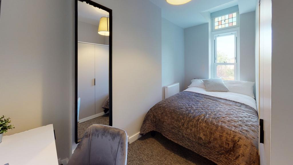 A stylish and well-lit double bedroom featuring...