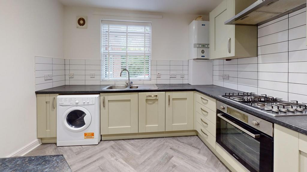 A modern and tidy kitchenette featuring ample s...