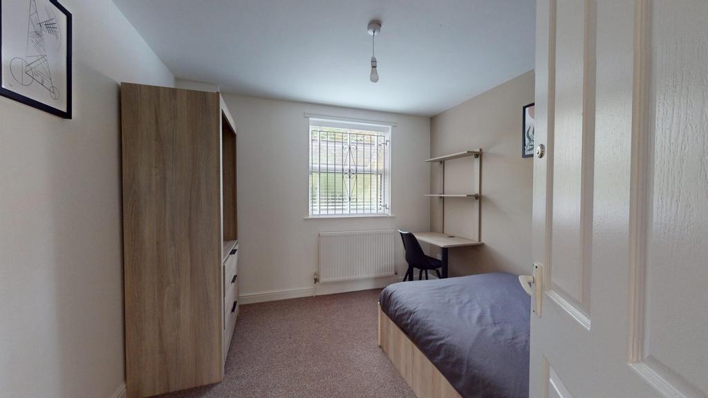 A bright and tidy double bedroom featuring a co...