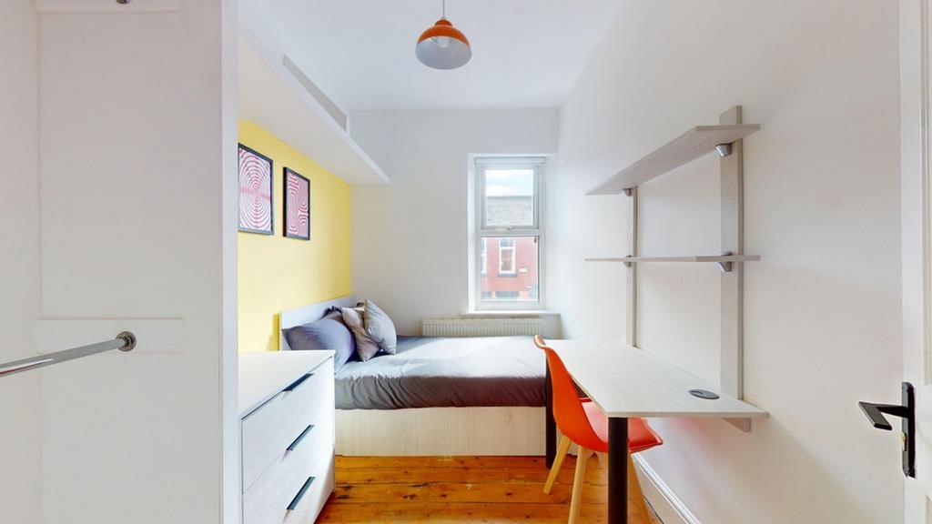 A bright and inviting double bedroom featuring ...