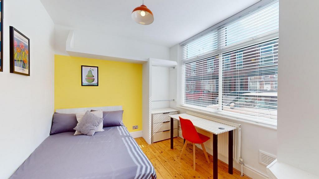 A bright and inviting double bedroom with moder...