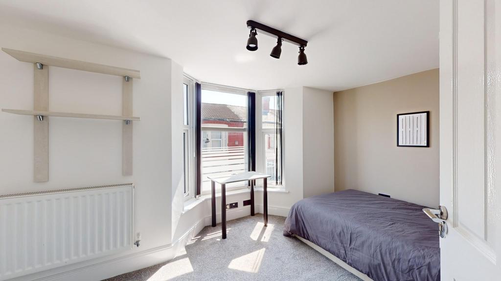 A bright and spacious double bedroom featuring ...