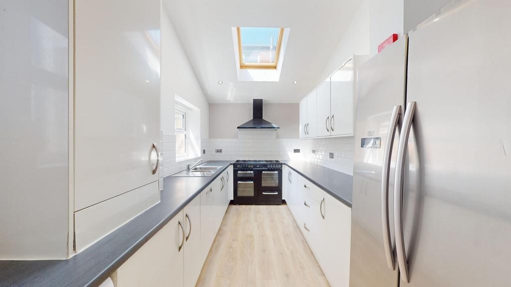 A bright and modern kitchen featuring sleek cab...