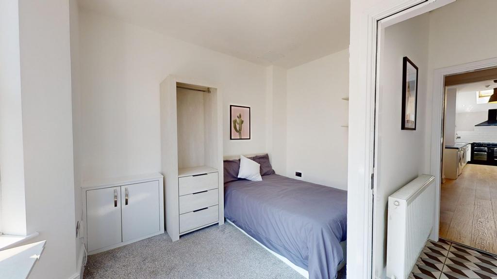 A bright and inviting double bedroom featuring ...