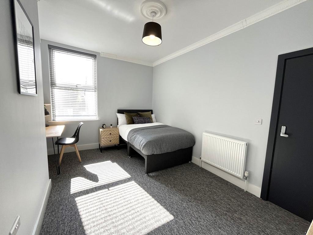 A bright and spacious double bedroom featuring ...