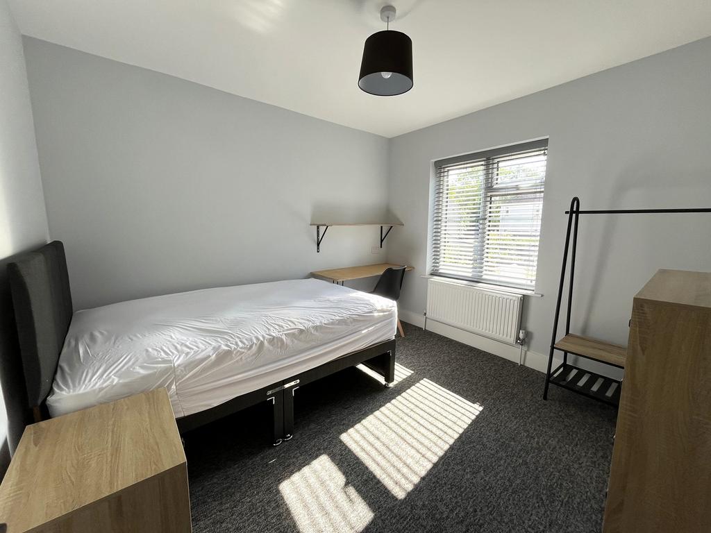 A bright and spacious double bedroom featuring ...