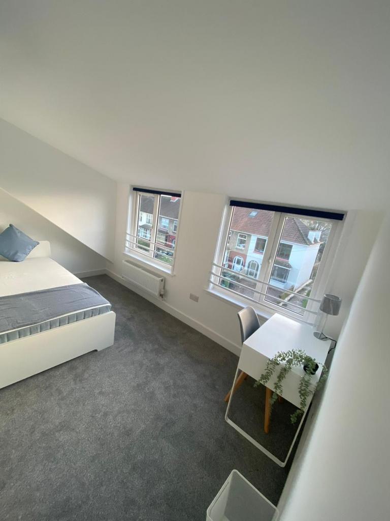 A bright and spacious double bedroom with large...