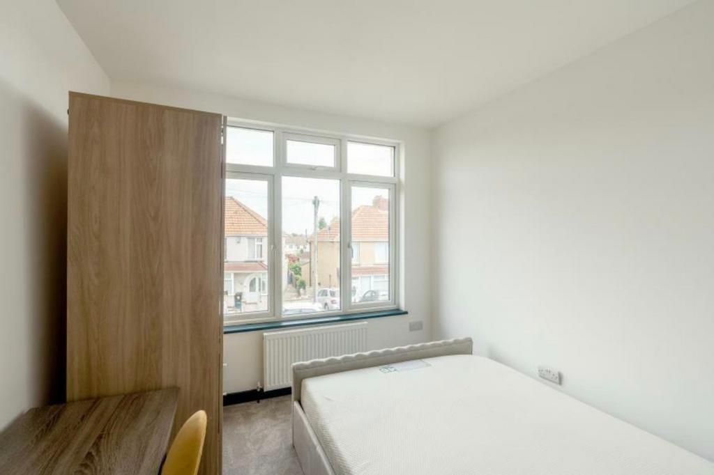 A bright and spacious double bedroom with large...