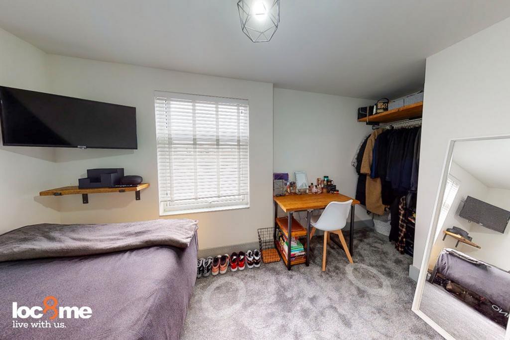 A bright and tidy double bedroom featuring a co...