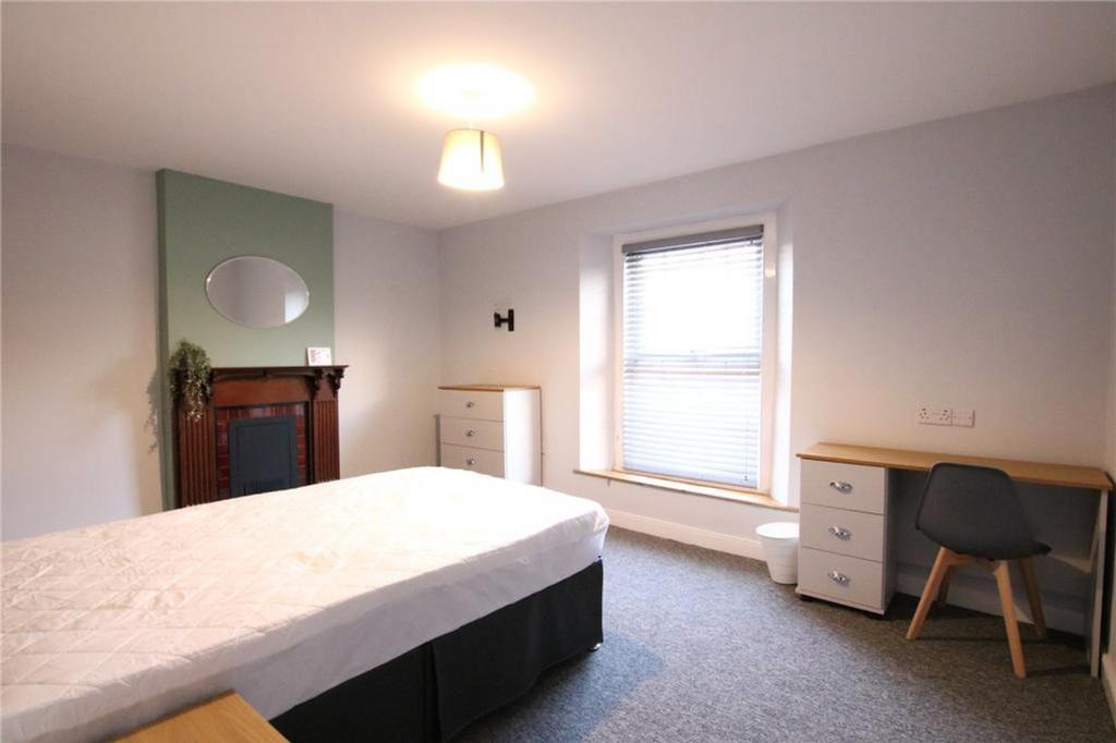 A spacious and inviting double bedroom featurin...