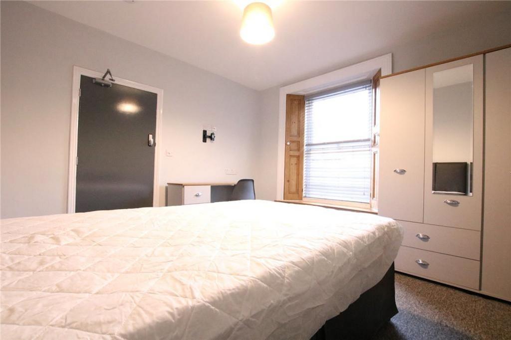 A bright and tidy double bedroom with a comfort...