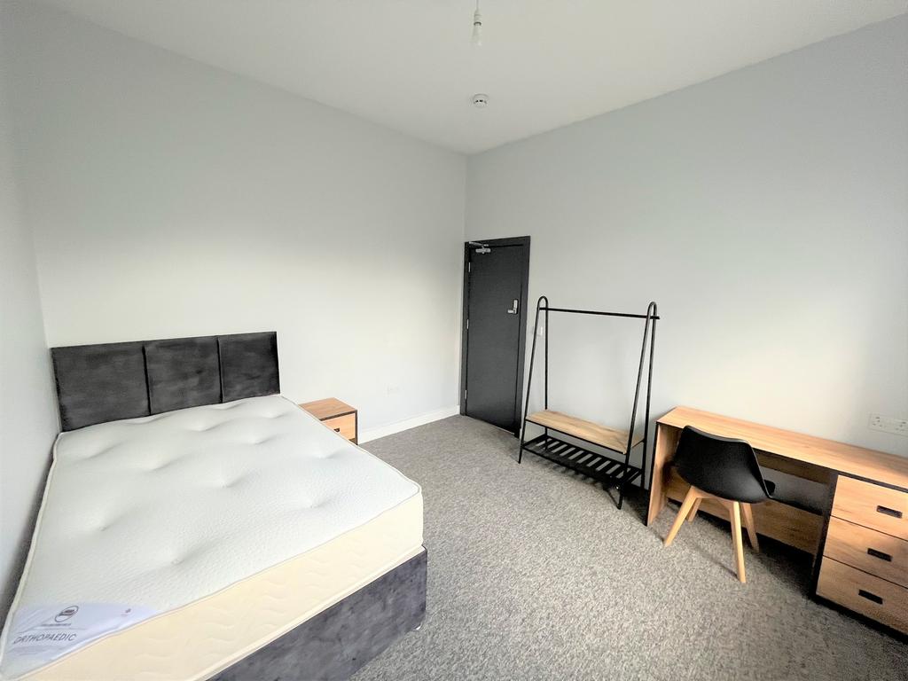 A spacious and well lit double bedroom, perfect...