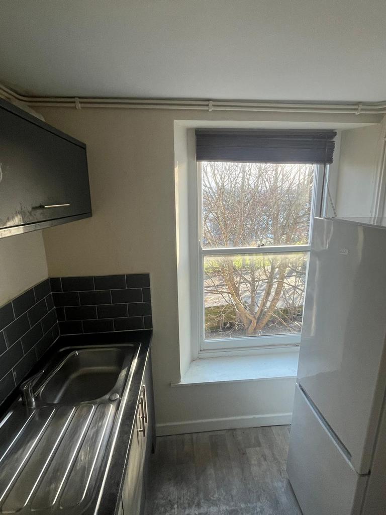 A bright and tidy kitchenette with modern fixtu...