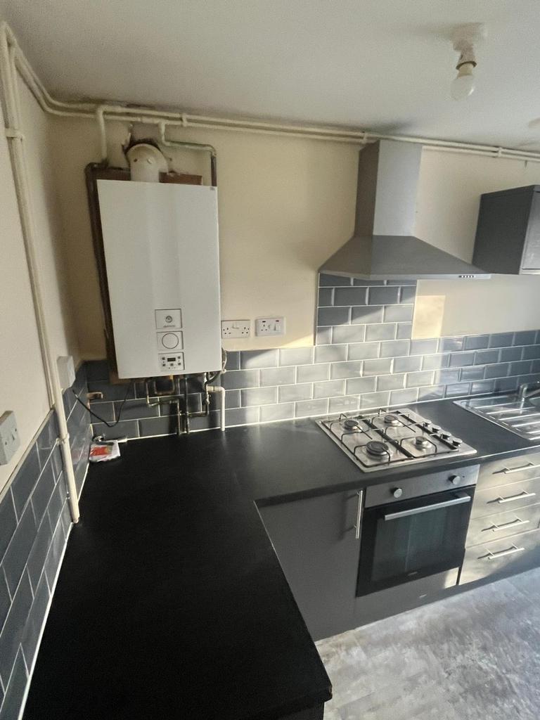 A modern and tidy kitchenette featuring sleek b...