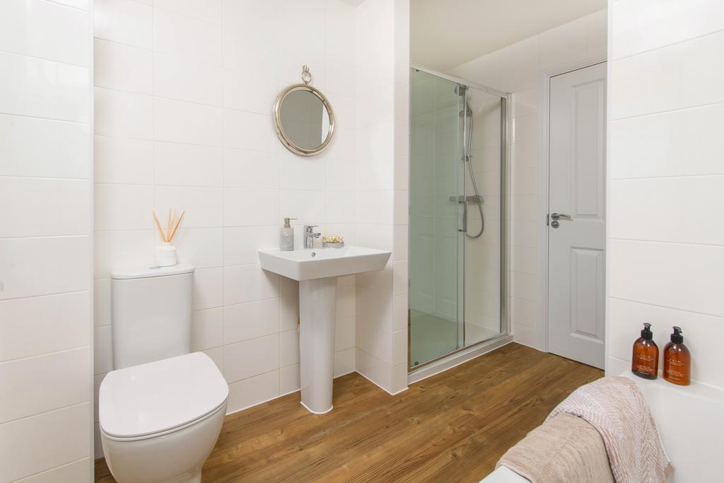 Family bathroom with shower over bath &amp; storage