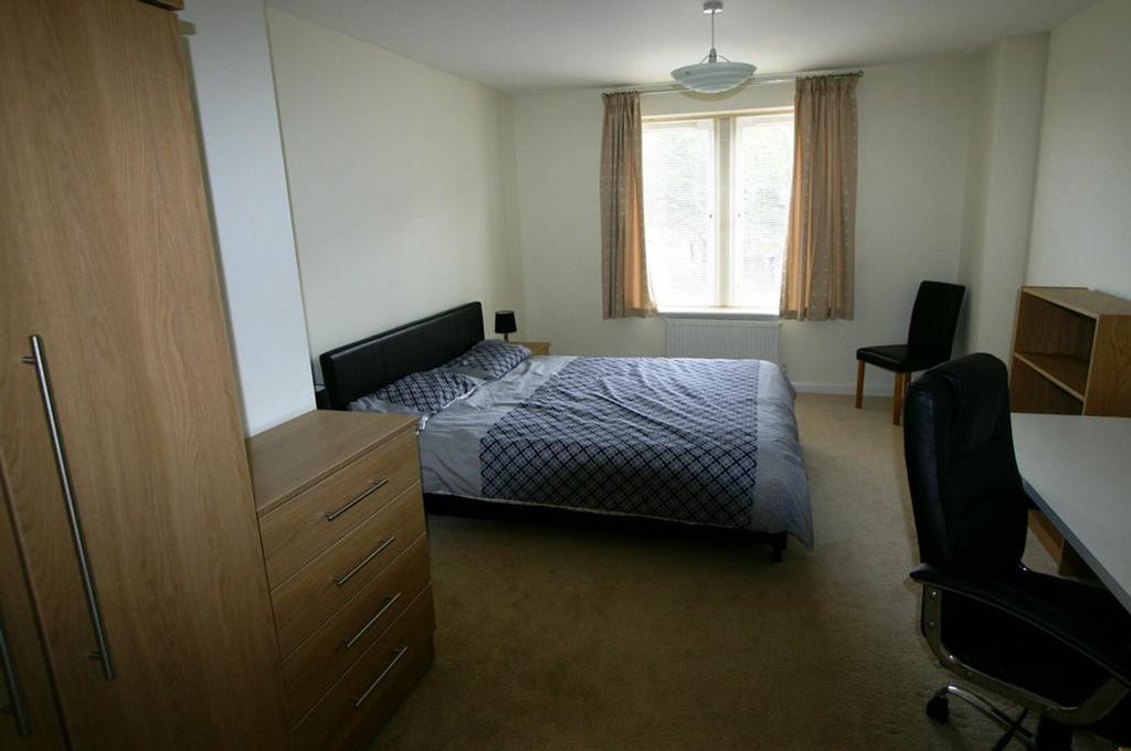 A bright and spacious double bedroom with moder...