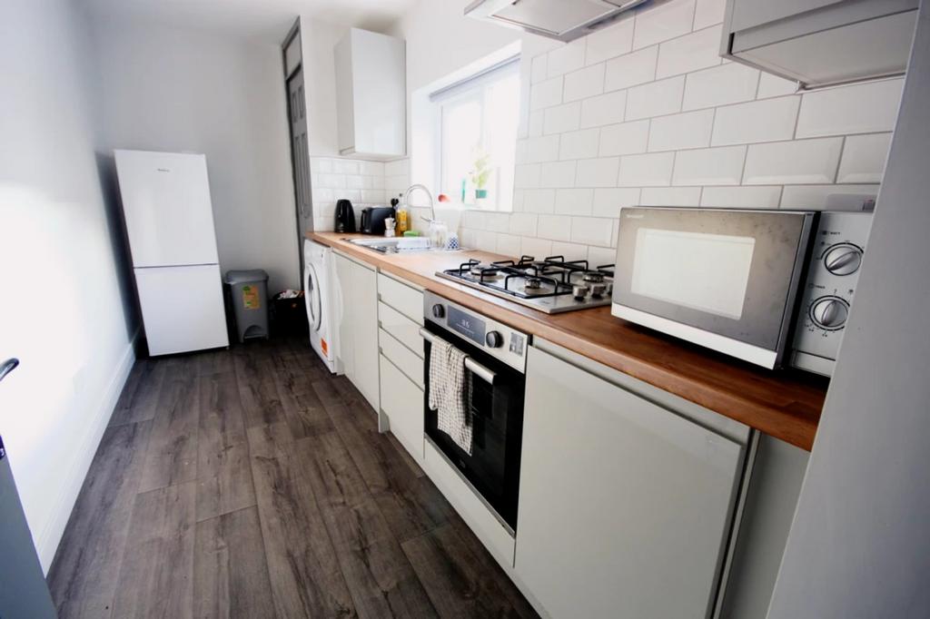 A bright and modern kitchenette featuring ample...