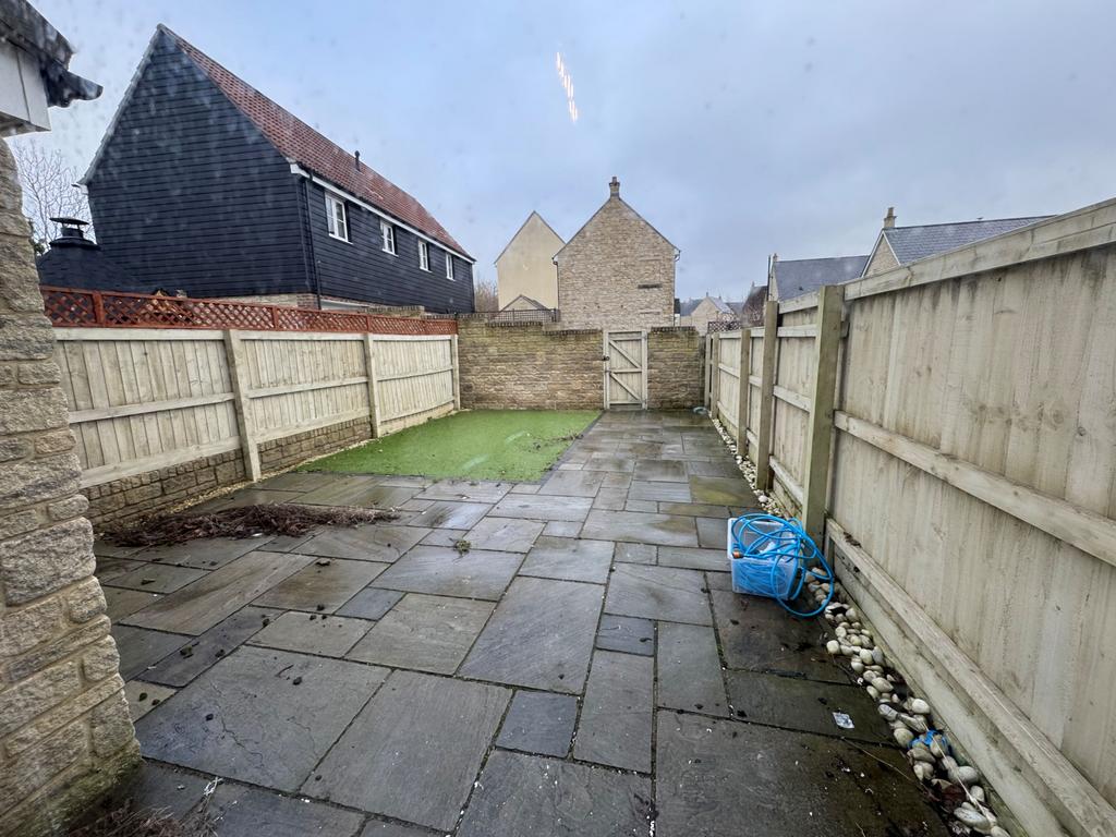 Garden with gate to rear parking space and garage