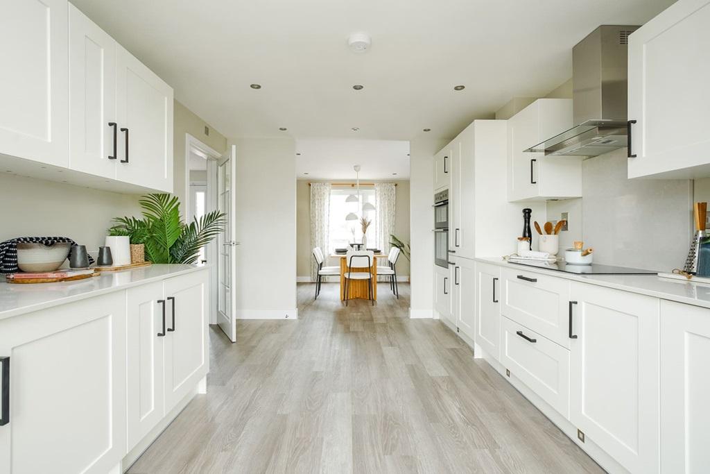 The kitchen leads through to the dining area,...