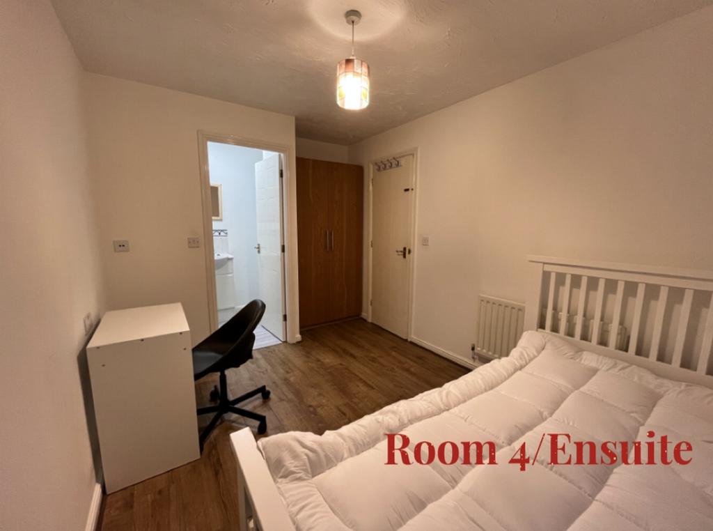 A bright and inviting double bedroom with an en...