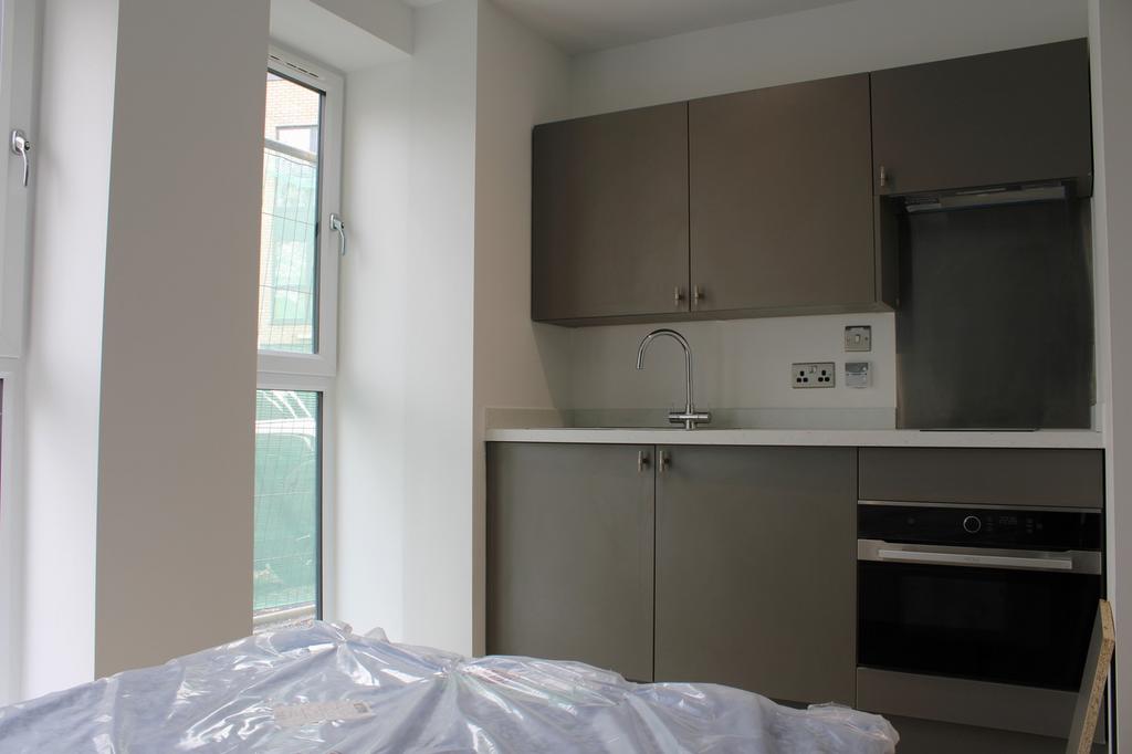 A modern kitchenette with ample natural light, ...