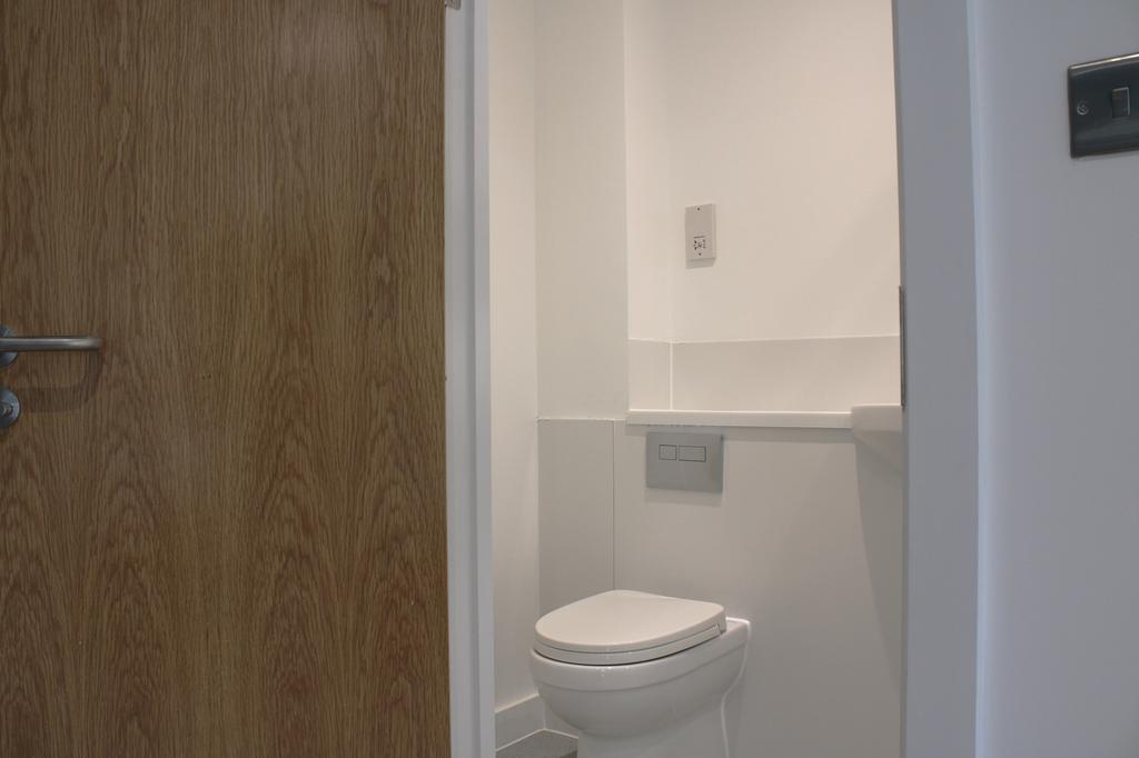 A pristine and modern single toilet, featuring ...