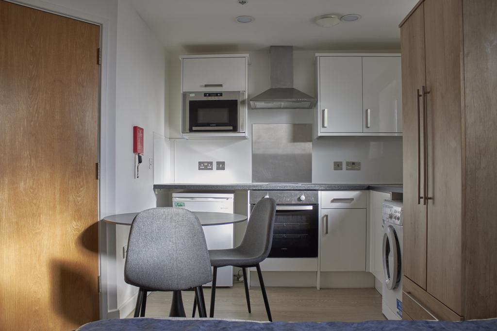 A modern and tidy kitchenette featuring sleek a...