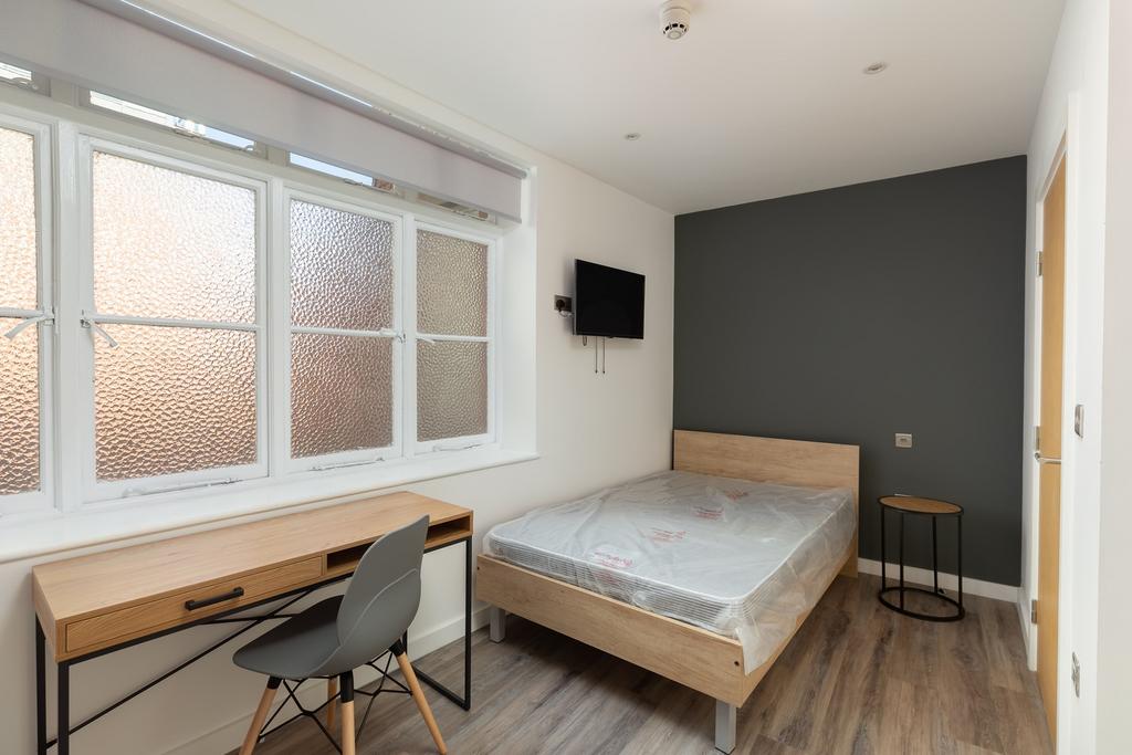 A bright and modern double bedroom featuring a ...