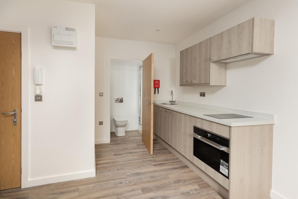 A modern and tidy kitchenette with ample cabine...