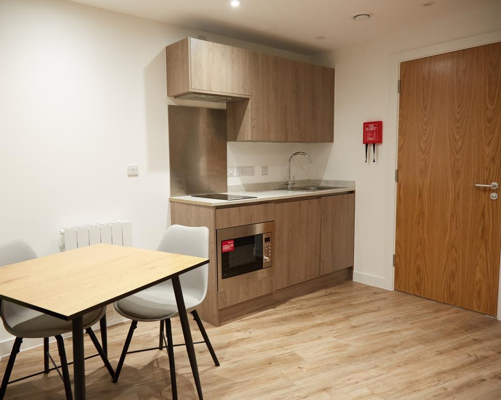 A modern kitchenette with sleek cabinetry and a...