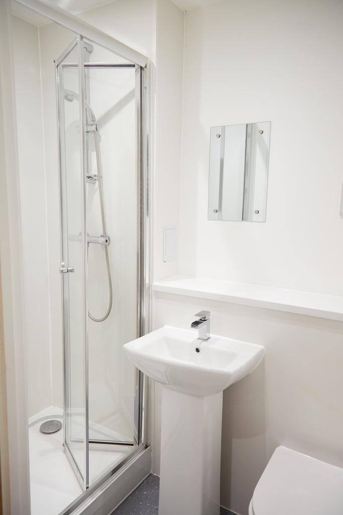 A modern and immaculate bathroom featuring a sl...