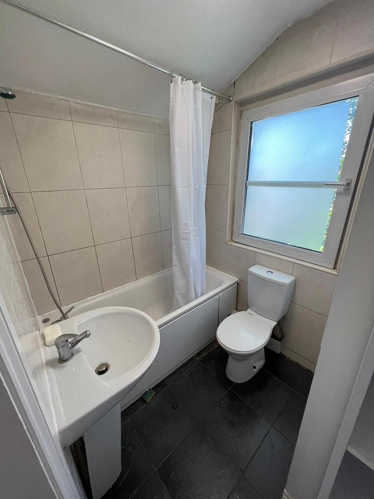 A tidy and well maintained bathroom featuring a...