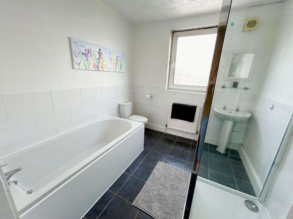 A spacious and bright bathroom featuring a mode...