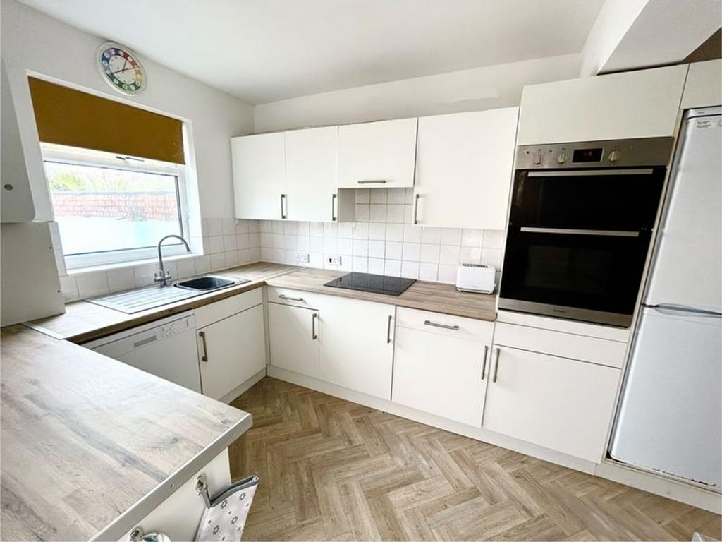 A modern and tidy kitchen featuring sleek cabin...