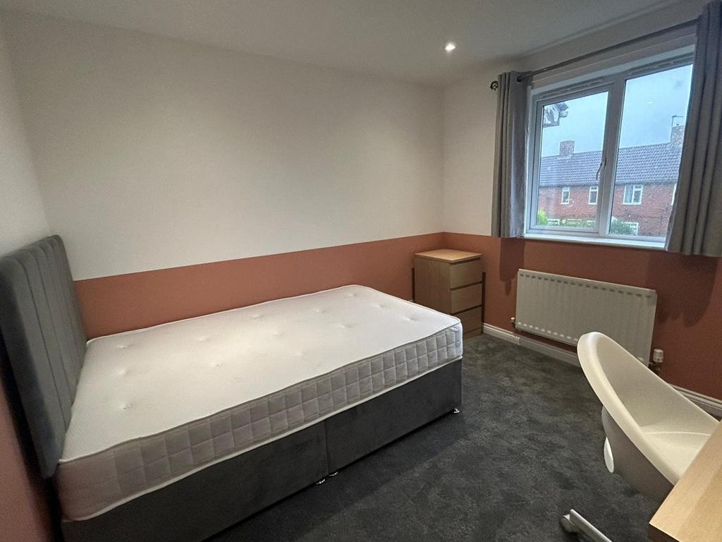 A spacious and inviting double bedroom with goo...