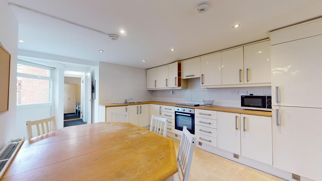 A spacious and bright kitchen featuring modern ...