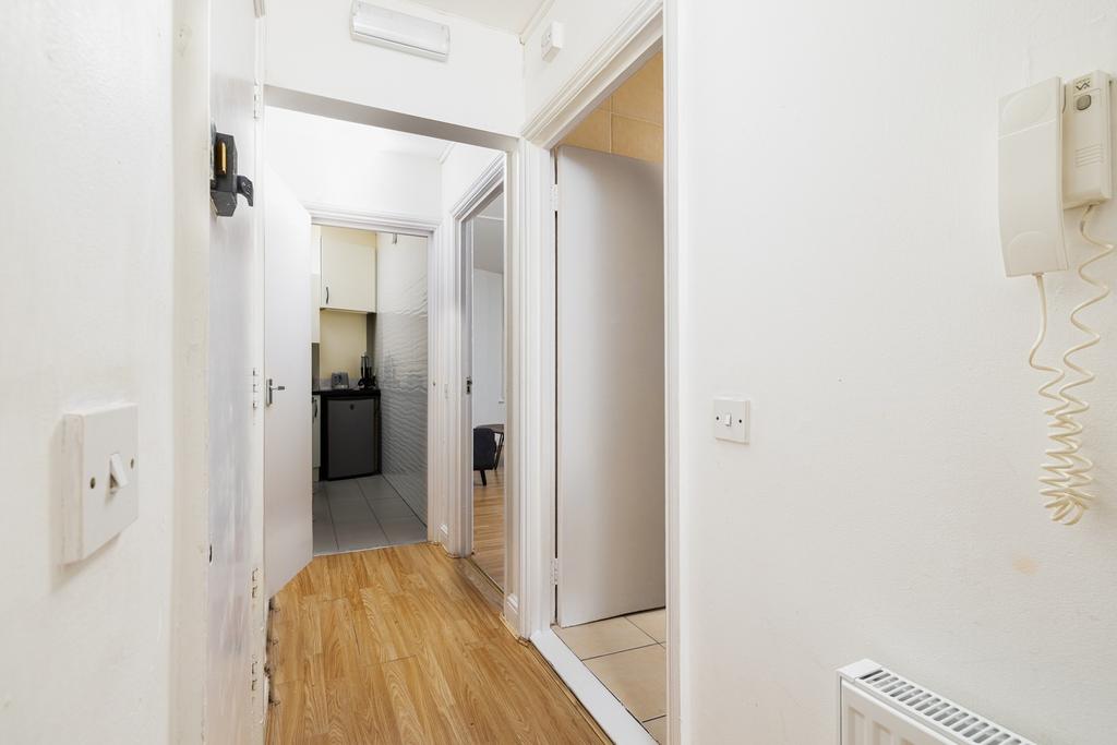 A spacious and tidy hallway that leads to vario...