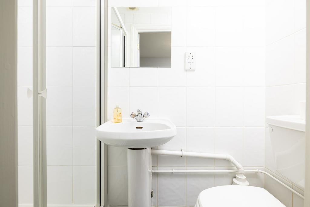 A bright and tidy bathroom featuring modern fix...