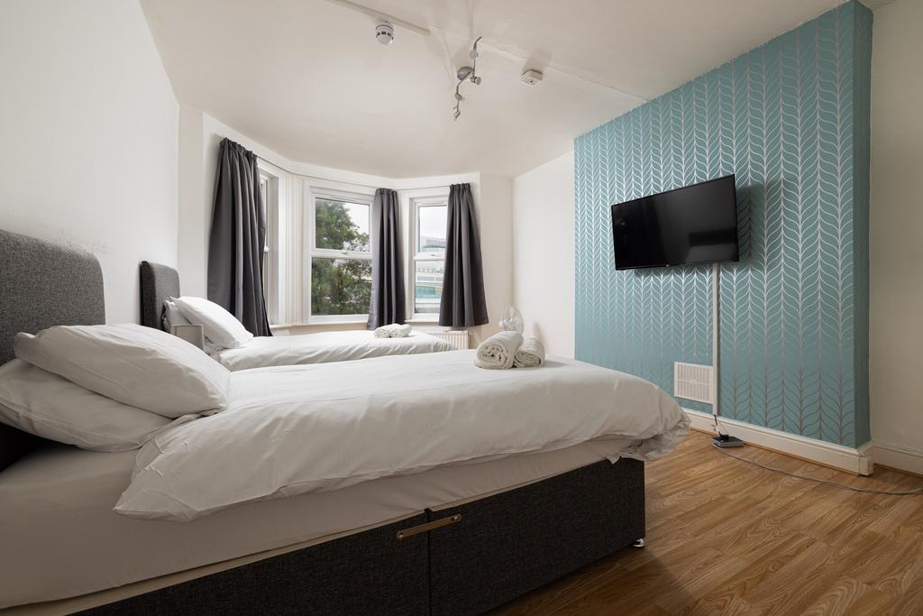 A spacious and inviting double bedroom with amp...