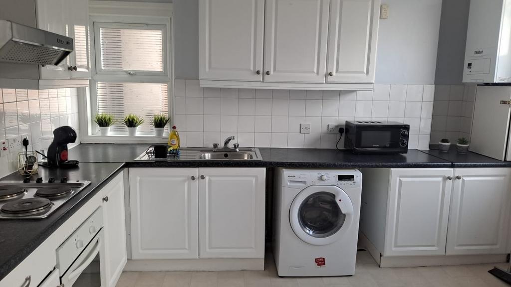 A bright and tidy kitchenette featuring modern ...